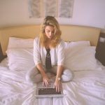 Woman, working, bed — Advanced CFD Trading Tools Review for Faster Analysis and Better Trading Performance