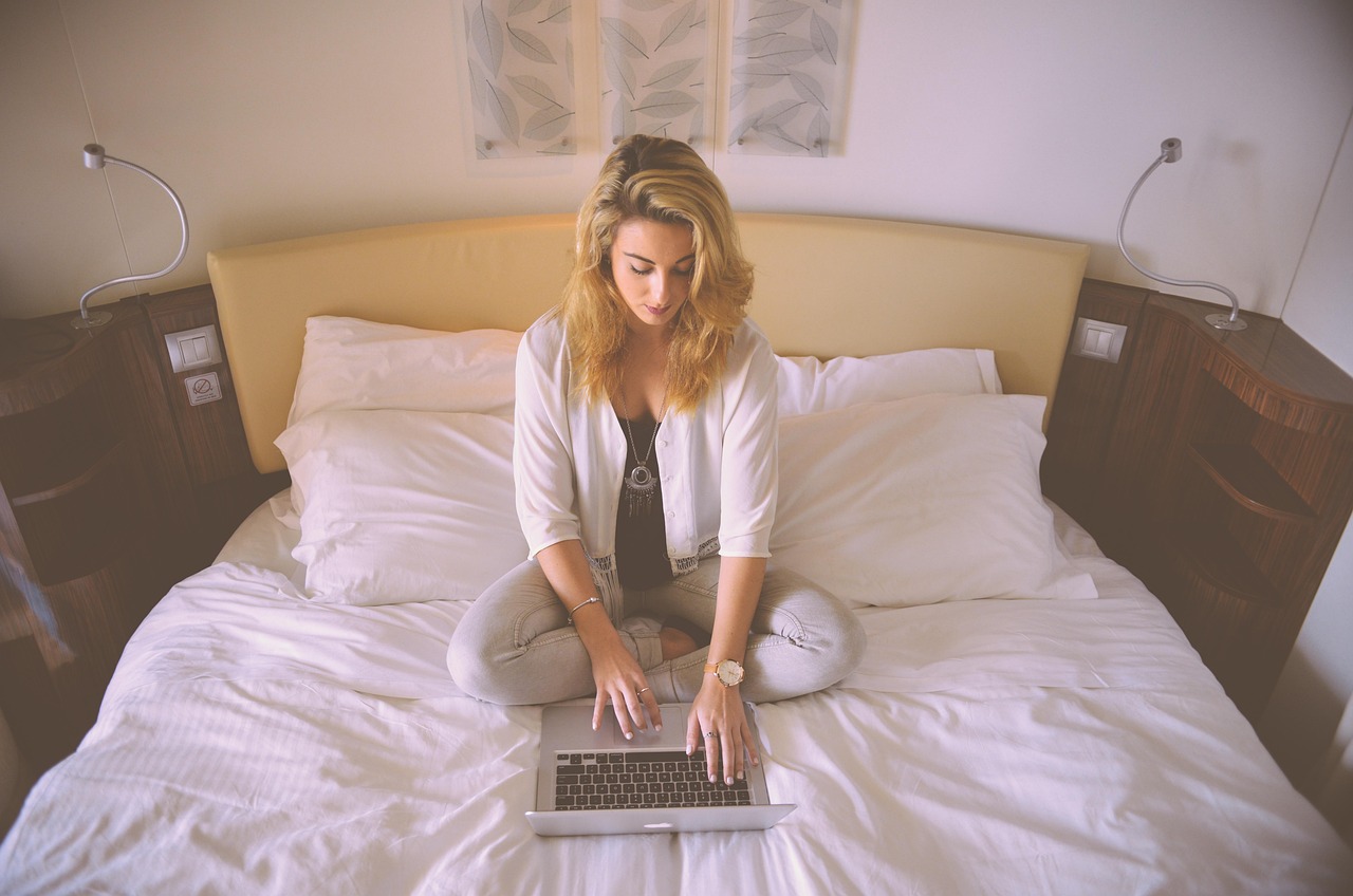 Woman, working, bed — Advanced CFD Trading Tools Review for Faster Analysis and Better Trading Performance